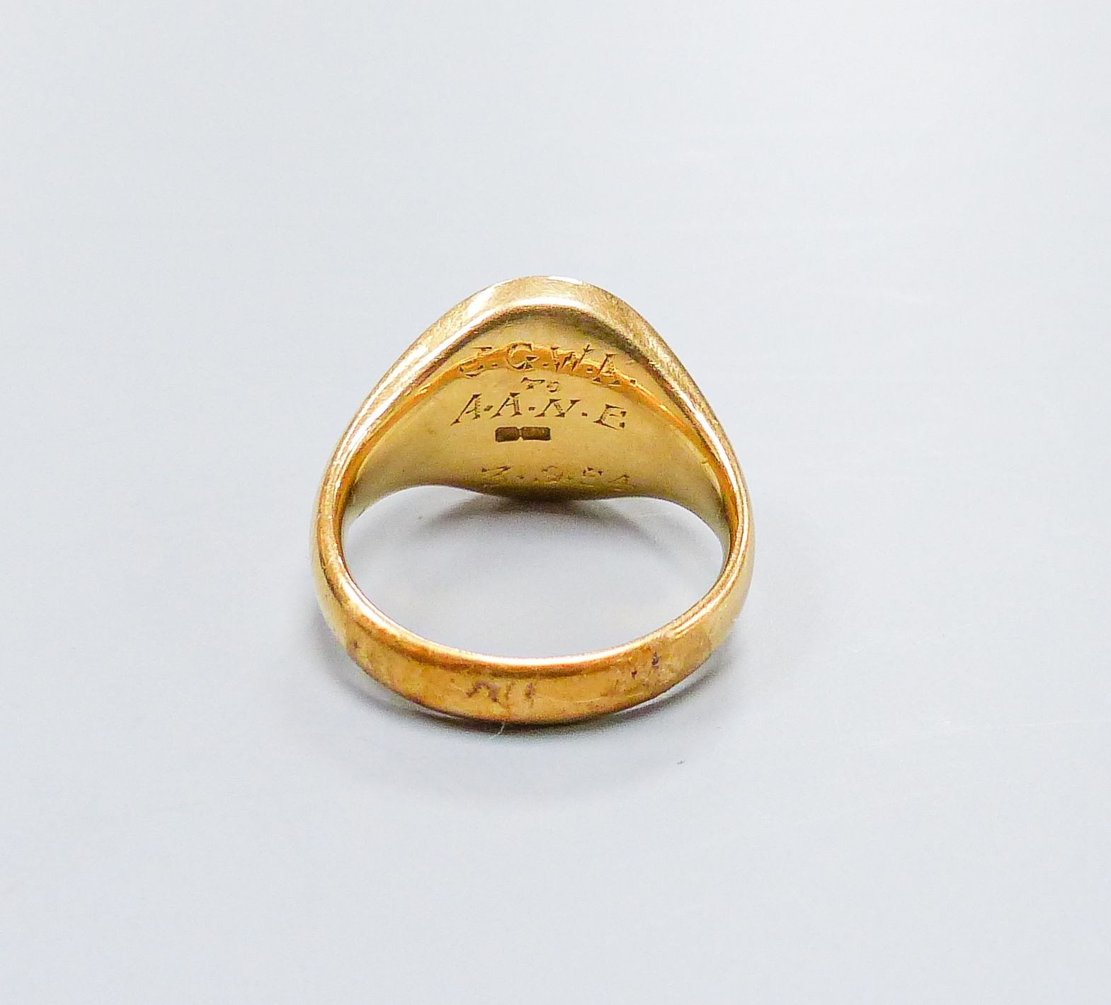 A 1950's 19ct gold signet ring, with engraved inscription, size M, 14.3 grams.